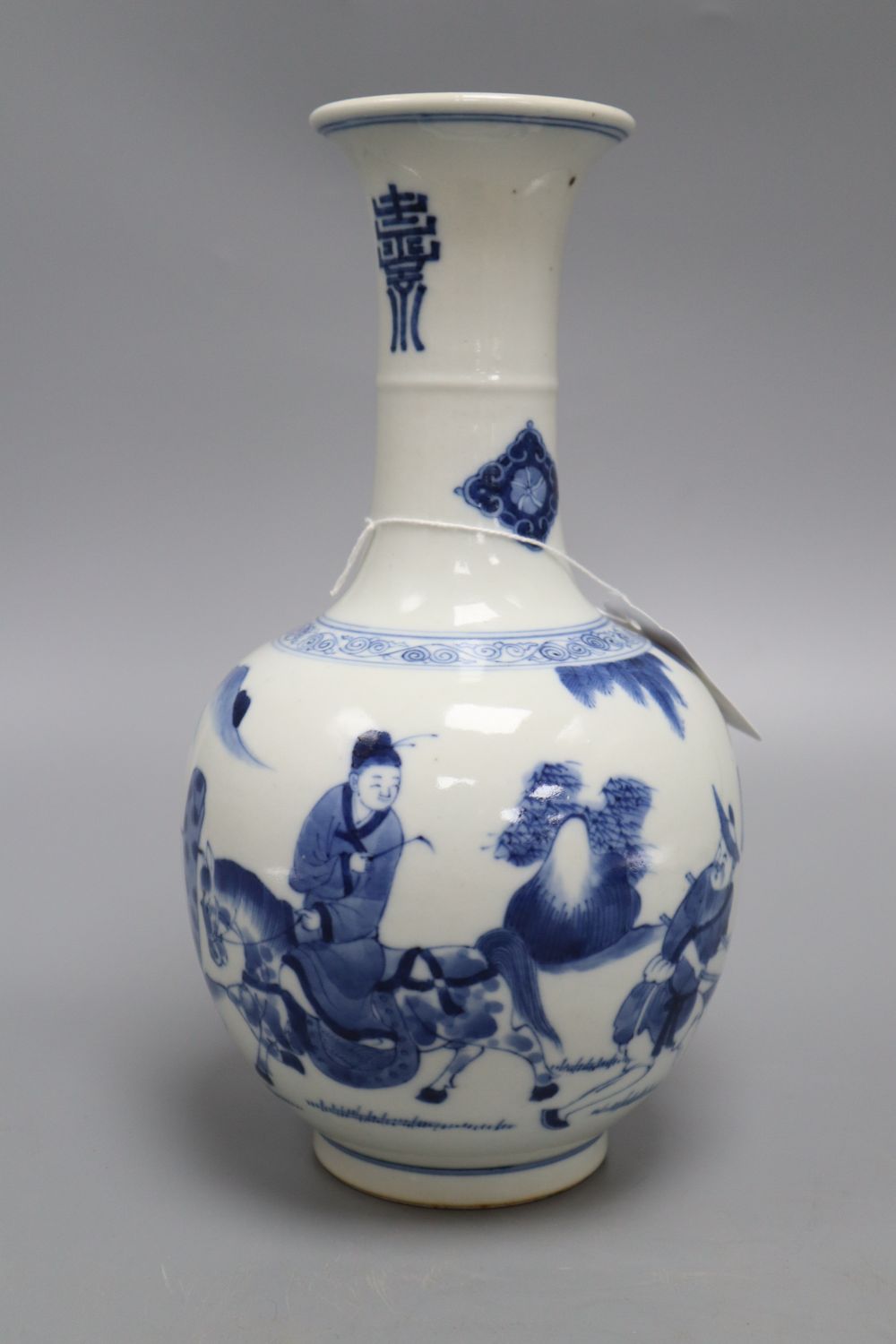 A Chinese blue and white figurative bottle vase, with four character mark to base, height 26cm
